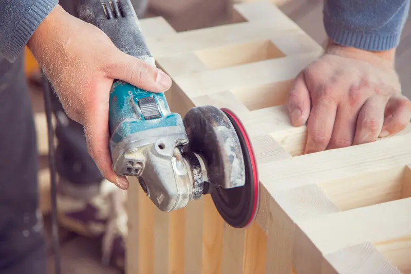 Close-up of a power saw cutting a wood board on a job site