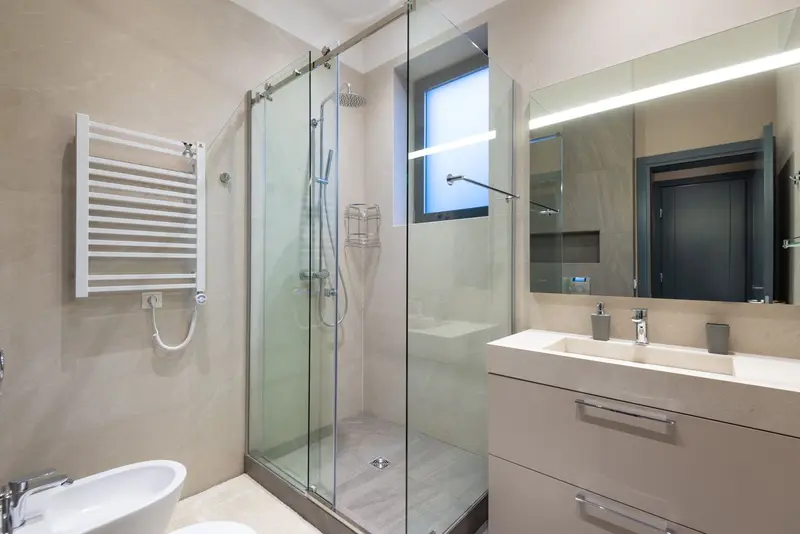 Bathroom with a glass shower enclosure and clean tile work